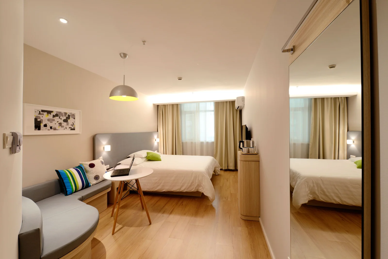 A furnished private bedroom with natural light